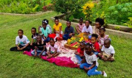 Children and families receiving agriculture supplies from Starfysh’s Life Garden on La Gonave.