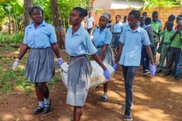 Students on La Gonave carrying planting supplies for a Starfysh school garden project.